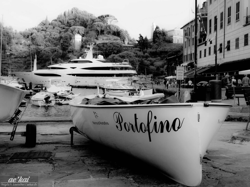 Black-and-white picture of a boat named Portofino in Portofino, Italy