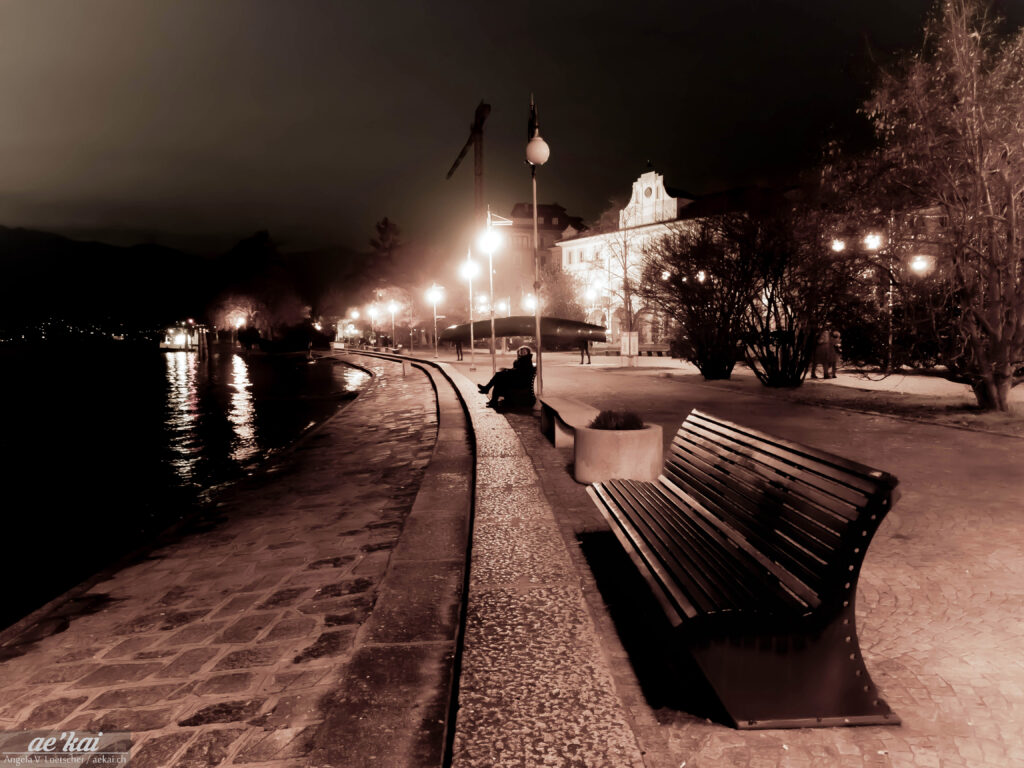 Sepia picture of a bench at night in Pallanza, Italy