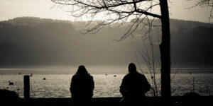 Two people together but alone at Greifensee, Switzerland