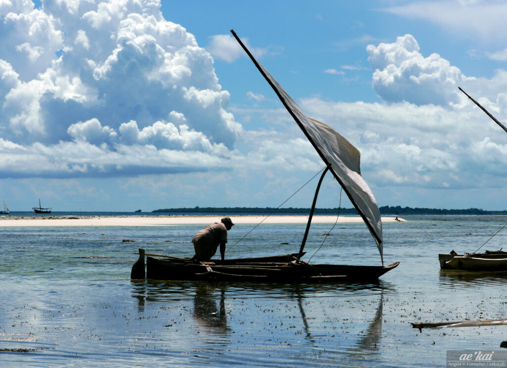 Fisher man with a traditional boat called a dhow in Zanzibar