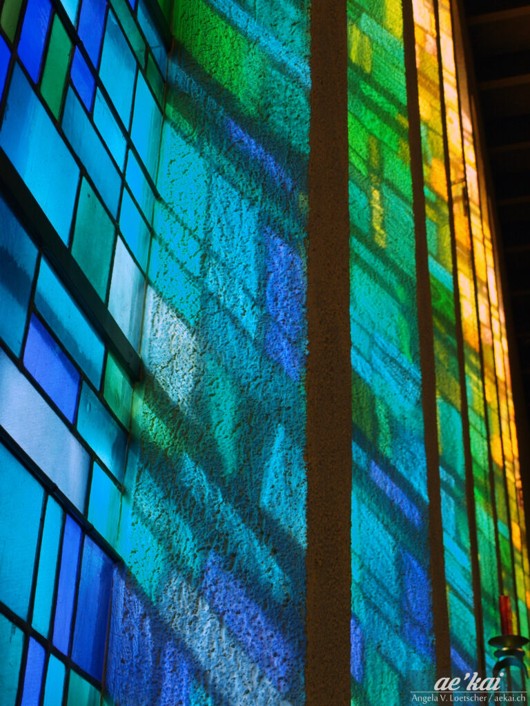 Buntglasfenster; blue-green-yellow stained glass of a church in Braunwald, Switzerland.