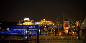 Hamburg harbor at night with musical halls in background