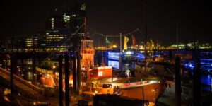 Hamburg harbor at night with Hafen City in background