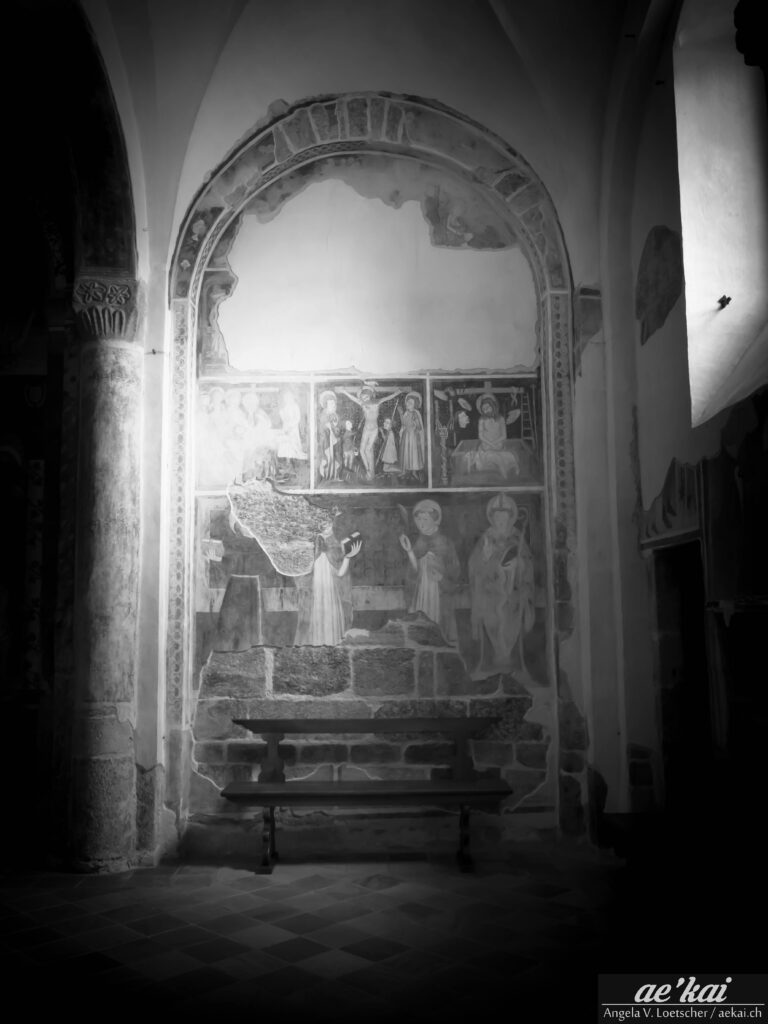 Black and white picture of a church bench in San Giulio, Italy.