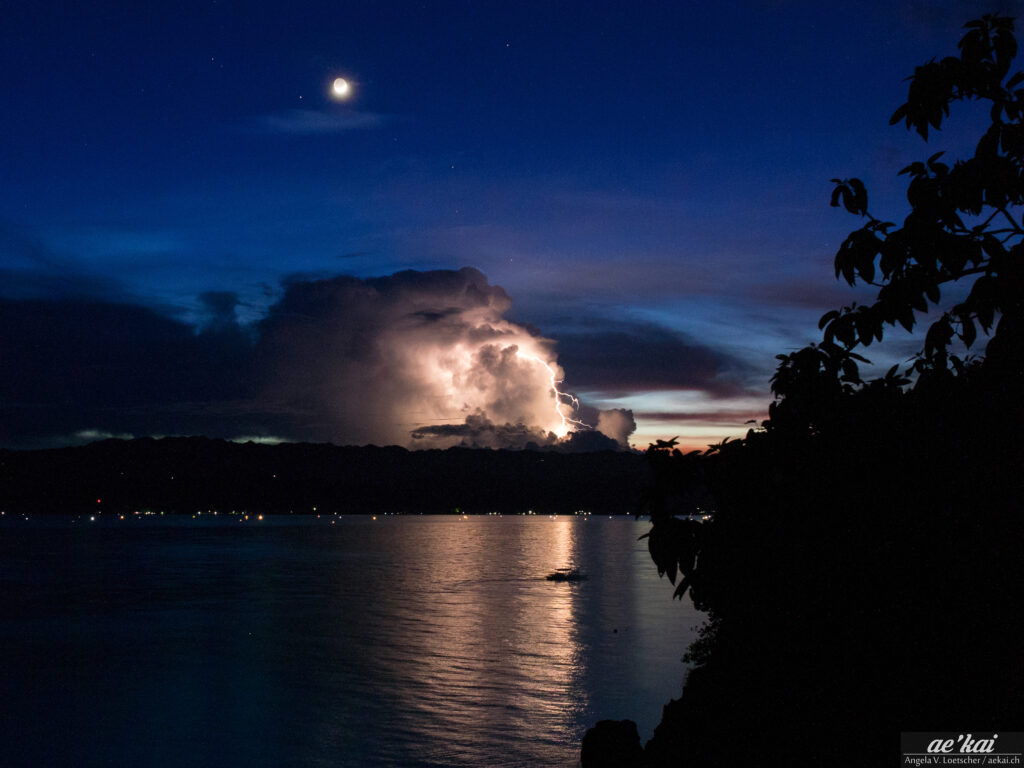Heat lightning in the philippines with visible lightning and full moon