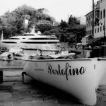 Black-and-white picture of a boat named Portofino in Portofino, Italy