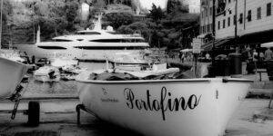 Black-and-white picture of a boat named Portofino in Portofino, Italy