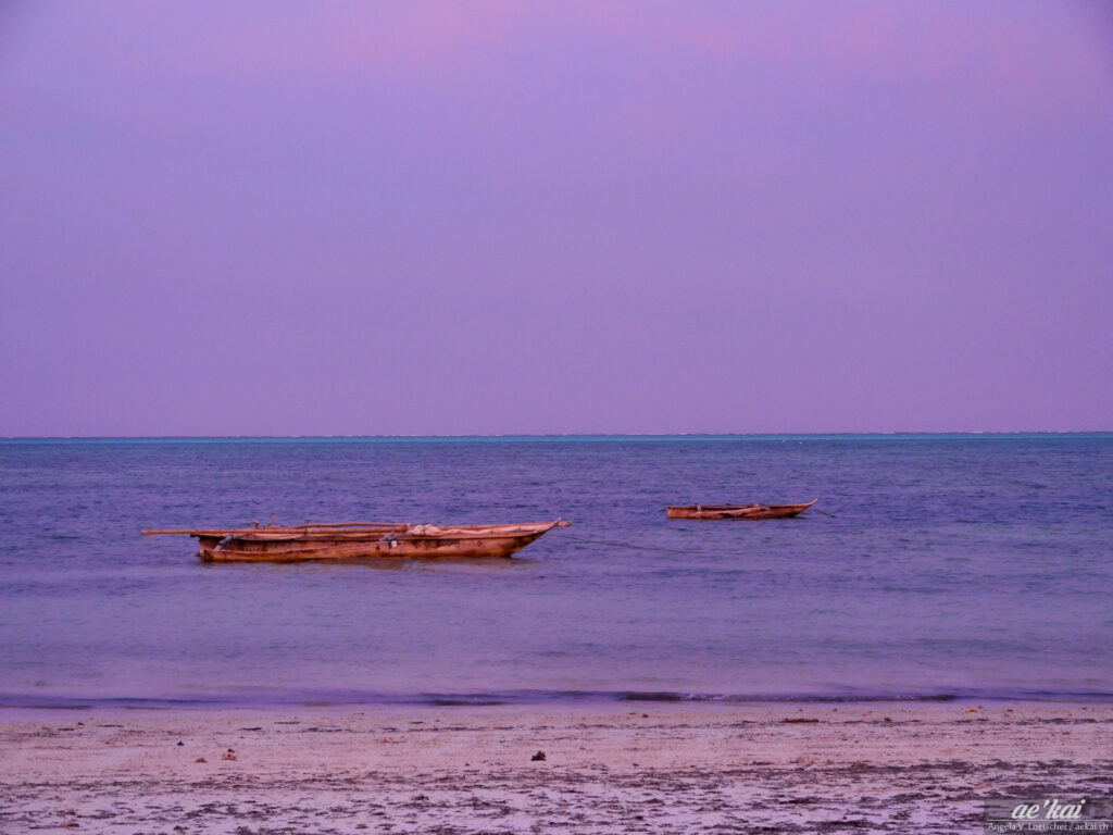 Purple-pink-blue Sunset at Jambiani Beach in Zanzibar, Tanzania, with two boats