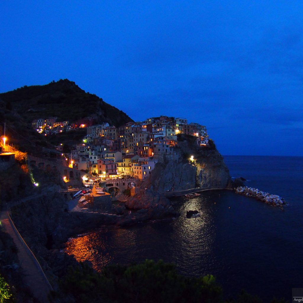 Manarola by night, blue hour and painted houses; Cinque Terre